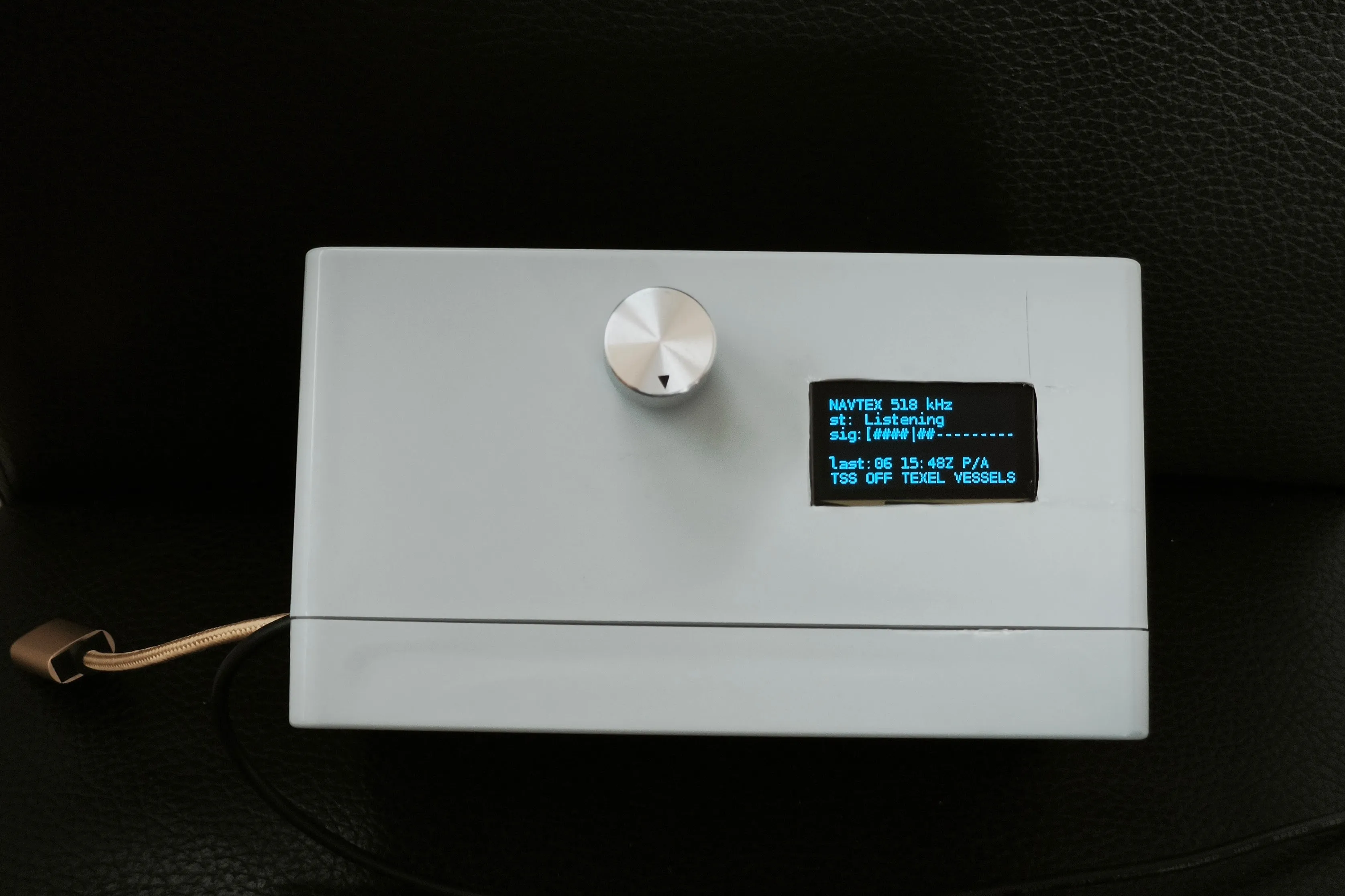 The Raspberry Pi Zero 2 W in a small project box with a knob encoder and a small OLED display.